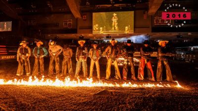 Image of cowboys standing in a line during rodeo at TD Place in 2016