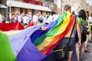 Man holding rainbow flag at Pride Parade
