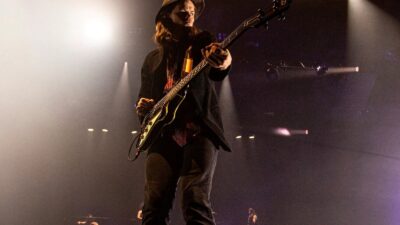 Image of a guy playing bass on stage