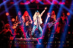 Image of the cast of Rock of Ages performing on stage at TD Place